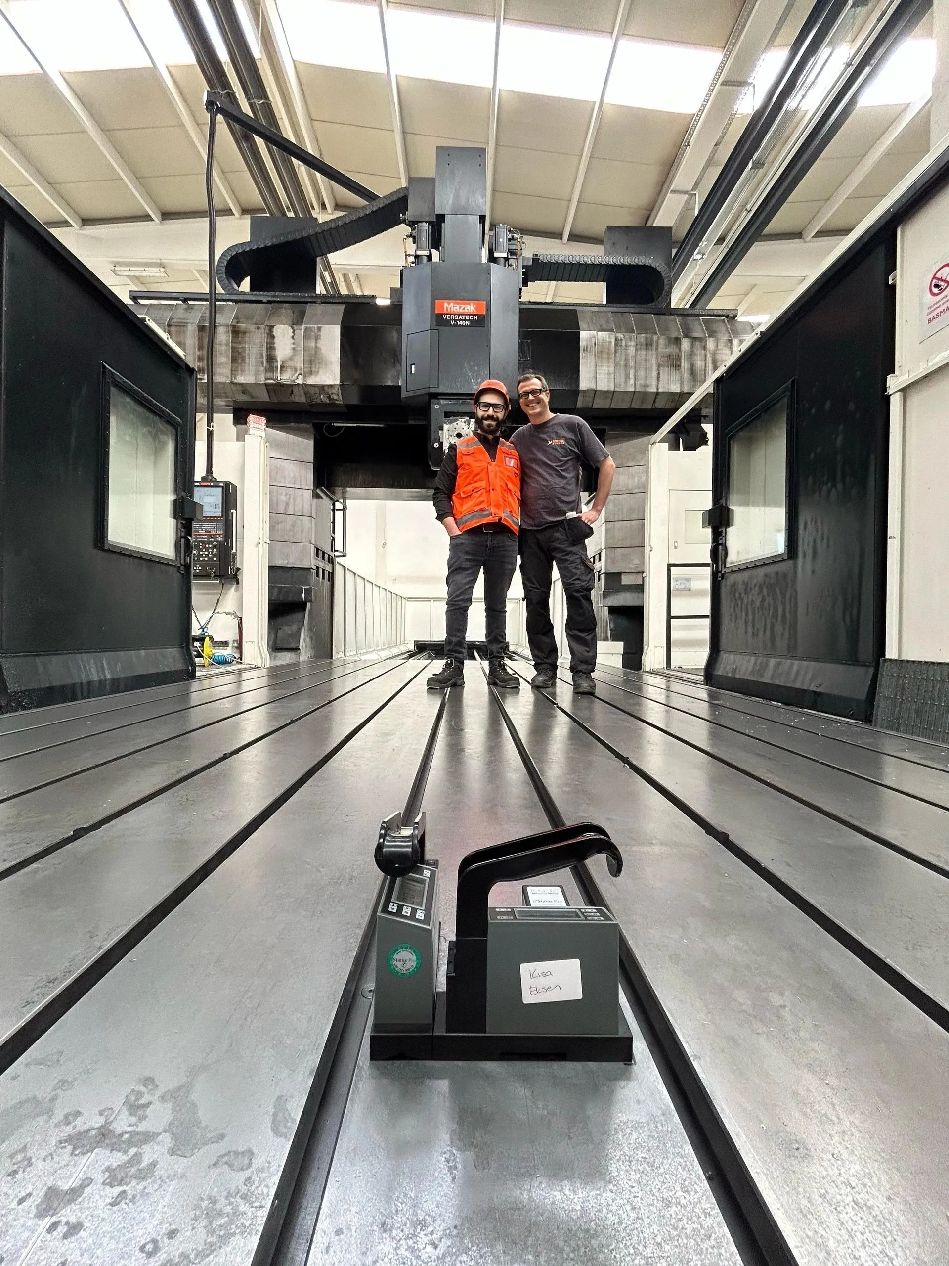 Our team on the table of a gantry machine, digital level in front